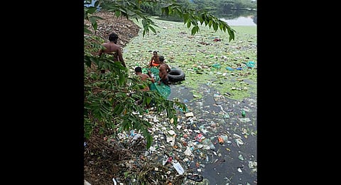 Manual labourers have been working to remove garbage from the Putheri Lake since Wednesday | Express