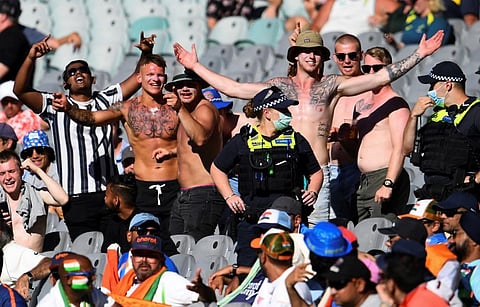 Police stand by as Australia fans heckle Indian supporters (in foreground) on the first day of the second cricket Test match between Australia and India at the MCG in Melbourne. (Photo | AFP)