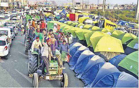 Farmers on tractors shout slogans at the Ghazipur border in New Delhi on Monday during their protest against the Centre’s new farm laws. (Photo | Parveen Negi, EPS)