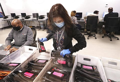 Election workers tabulate ballots at the Beauty P. Baldwin Voter Registrations and Elections Building, Tuesday, Jan. 5, 2021. (Photo | AP)