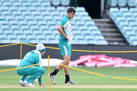 Australia's captain Tim Paine (L) checks the pitch area with Pat Cummins during a training session at the Sydney Cricket Ground. (Photo | AFP)