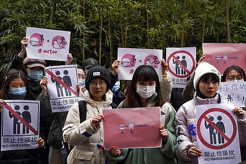 Supporters hold banners as they wait for of Zhou Xiaoxuan outside at a courthouse where Zhou is appearing in a sexual harassment case in Beijing last year. (Photo | AP)