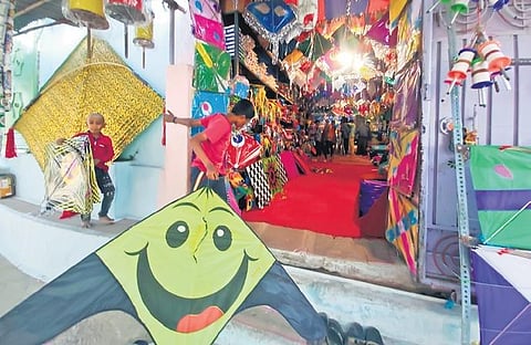 Kids check out kites at a shop in Dhoolpet, Hyderabad. (Photo | EPS/S Senbagapandiyan)