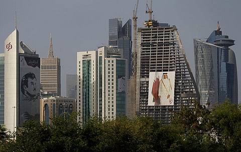 In this May 5, 2018, file photo, the images of the Emir of Qatar, Sheikh Tamim bin Hamad Al Thani hang on the towers in Doha. (Photo | AP)