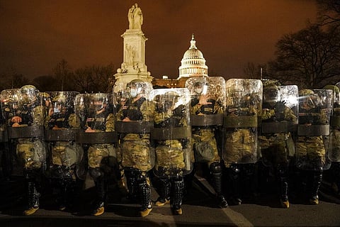 District of Columbia National Guard stand outside the Capitol, Wednesday night after a day of rioting protesters. (Photo | AP)