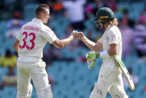 Australia's Will Pucovski, right, is congratulated by teammate Marnus Labuschagne after having his dismissal over-ruled on a video review. (Photo | AP)