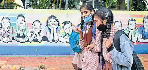Children wearing masks head to their school near Ramakrishna Ashram in Bengaluru on Thursday | Shriram BN