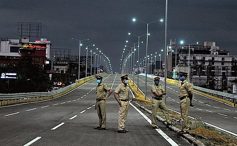 Police personnel stand guard at the Kundannoor flyover which is scheduled for inauguration on Saturday | A Sanesh