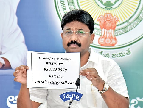 Education Minister Audimulapu Suresh shows the number to file complaints against errant educational institutes, in Velagapudi on Friday I Express