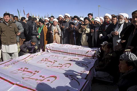 People attend the funeral prayer of coal mine workers who were killed by gunmen near the Machh coal field in Quetta, Pakistan. (Photo | AP)