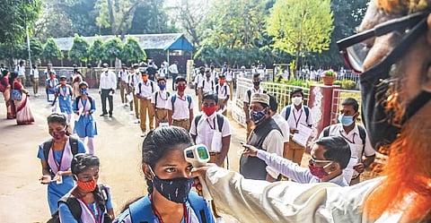 Students being screened before entering into Capital High School as classes commenced in Bhubaneswar. (Photo | Express)