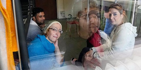 Boshra al-Moallem, bottom left, looks out of the window as she sits in a room with her two sisters and brother-in-law at a refugee center in Bialystok, Poland. (Photo | AP)
