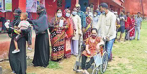 Voters stand in queue at a polling centre in Pipili on Thursday. (Photo | Express)