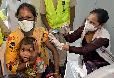 A beneficiary reacts while receiving a dose of the COVID-19 vaccine during Mega vaccination drive. (Photo | ANI)