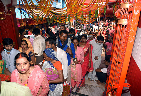 Devotees stand in queues to offer prayers during Navratri festival at a temple, in Patna on Sunday. (Photo | ANI)