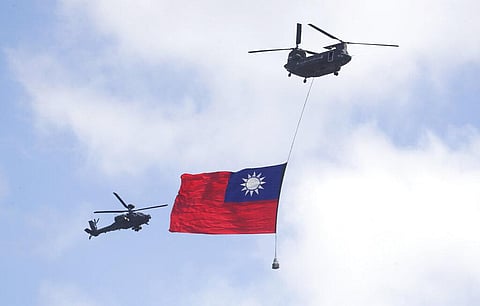Helicopters fly over President Office with Taiwan National flag during National Day celebrations in front of the Presidential Building in Taipei, Taiwan. (Photo | AP)