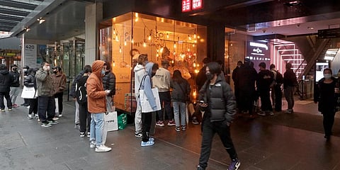 Customers line up to enter a store in the central business district after more than 100 days of lockdown to help contain the COVID-19 outbreak in Sydney. (Photo | AP)