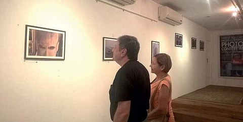 People view the photographs displayed at Rohini Art Gallery
