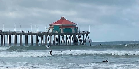 Surfers and swimmers return to the Huntington Beach pier waves since the crude oil spill at the California beach. (Photo | AP)