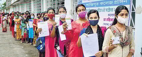 Students stand in a queue to receive a dose of the COVID-19 vaccine in Nadia, West Bengal. (File Photo | PTI)
