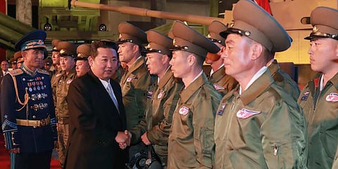 North Korean leader Kim Jong Un, second from left, meets fighter pilots who made the demonstration flight at the opening of an exhibition of weapons systems in Pyongyang. (Photo | AP)