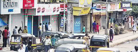 People find themselves in front of closed shops in Mumbai. (Photo | PTI)