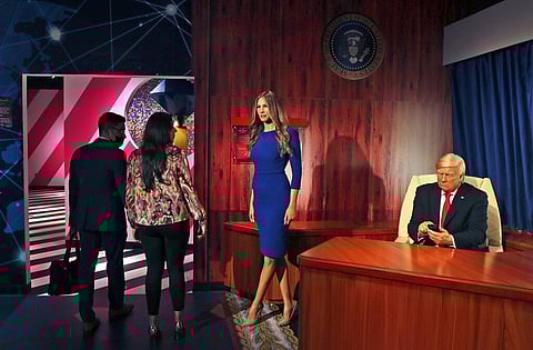 People visit the wax versions of former U.S. President Donald Trump and his wife Melania at the opening of the Madame Tussauds museum, in Dubai. (Photo | AP)