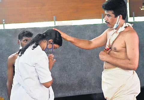 One of the 22 women receives ‘deeksha’ from K V Subhash Thantri at Nagaraja Kshethram, Peramangalam | Express 