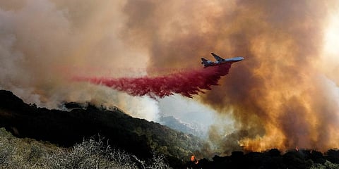 An air tanker drops retardant on a wildfire in Goleta, Calif. (Photo | AP)