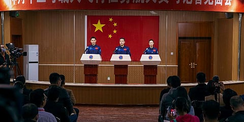 Chinese astronauts, from left, Ye Guangfu, Zhai Zhigang and Wang Yaping at a press conference at the Jiuquan Satellite Launch Center ahead of the Shenzhou-13 launch mission, Oct 14, 2021. (Photo | AP)