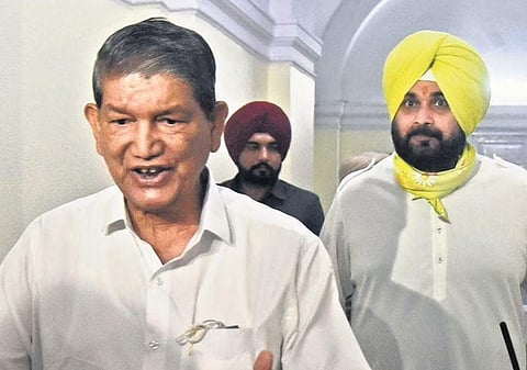 Navjot Singh Sidhu (R) with Harish Rawat in New Delhi on Thursday | Parveen Negi