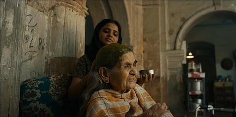 Farrukh Jaffar (sitting) in a still from Gulabo Sitabo. (Photo | YouTube screengrab)