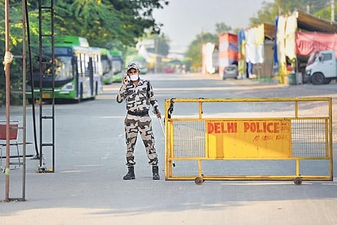 A security personnel keeps vigil at Singhu border near the site of the farmers’ protest, in Delhi on Friday | Pti