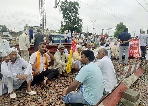 Farmers block railway tracks during 'Rail Roko Andolan' called by Samyukta Kisan Morcha in Ghaziabad on Monday. (Photo | ANI)