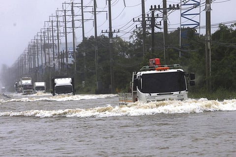 Trucks drive through flood waters in Nakhon Rachasima province, northeastern of Bangkok, Thailand (Photo | AP)