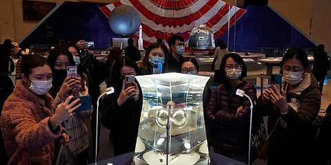 Visitors to the National Museum look at a display of the lunar rock samples retrieved from the moon by China's Chang'e 5 lunar lander late last year in Beijing. (File Photo | AP)