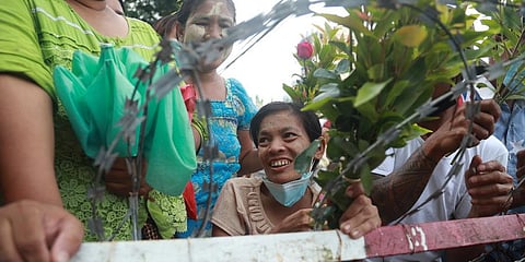 Family members and friends wait to welcome released prisoners outside the Insein Prison Tuesday, Oct. 19, 2021, in Yangon, Myanmar. (Photo | AP)