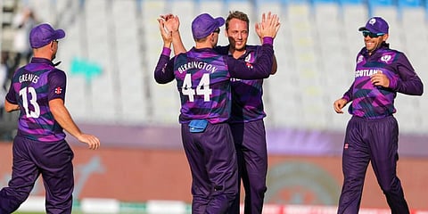 Scotland's Josh Davey celebrates a wicket with his teammates. (Photo | AP)