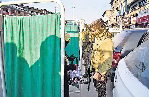 Female security personnel frisk commuters in Srinagar | Zahoor Punjabi