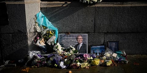 Floral tributes and pictures of British Member of Parliament David Amess lie placed outside the Houses of Parliament in London, Wednesday, Oct. 20, 2021. (Photo | AP)