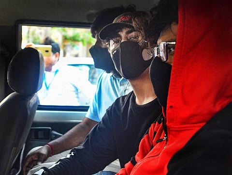 Bollywood actor Shahrukh Khan's son Aryan Khan being taken for his medical examination by NCB officials in connection with the drugs case. (Photo | PTI)