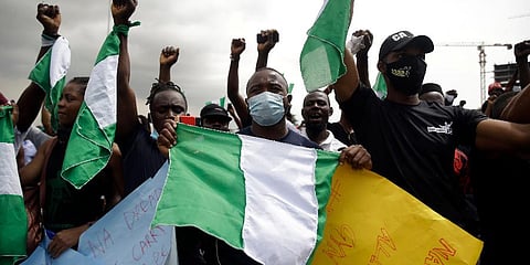FILE - In this Oct. 19, 2020, file photo, people hold banners as they demonstrate on the street to protest against police brutality in Lagos, Nigeria. (Photo | AP)