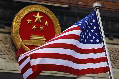 American flag is flown next to the Chinese national emblem during a welcome ceremony for visiting U.S.  (Photo | AP)