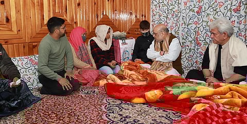 Amit Shah with the family of slain J-K policeman Parvaiz. (Photo | Twitter)