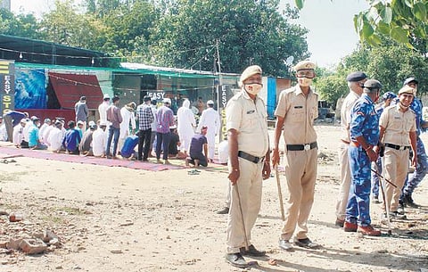 Members of the Muslim community conduct Friday prayers in an open site | Pti