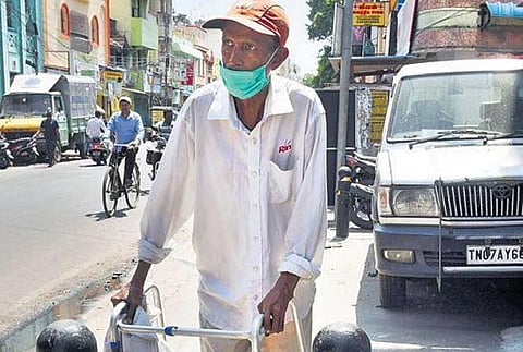 A man with locomotive disability tries to get past bollards on the footpath at Triplicane High Road | r satish babu