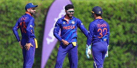 India's Ravindra Jadeja, centre, is congratulated by teammates Virat Kohli and Ishan Kishan for taking a wicket during WC warm-up game. (Photo | AP)