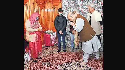 Amit Shah with the widow of J&K Police inspector Parvez Ahmed in Srinagar. (Photo | PTI)