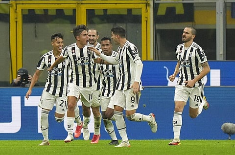 Juventus' Paulo Dybala, left, celebrates after scoring his side's opening goal during a Serie A soccer match between Inter Milan and Juventus at the San Siro stadium. (Photo | AP)