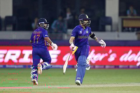 India's Rishabh Pant, left, and captain Virat Kohli run between the wickets during the ICC World T20 match between India and Pakistan in Dubai. (Photo | AP)